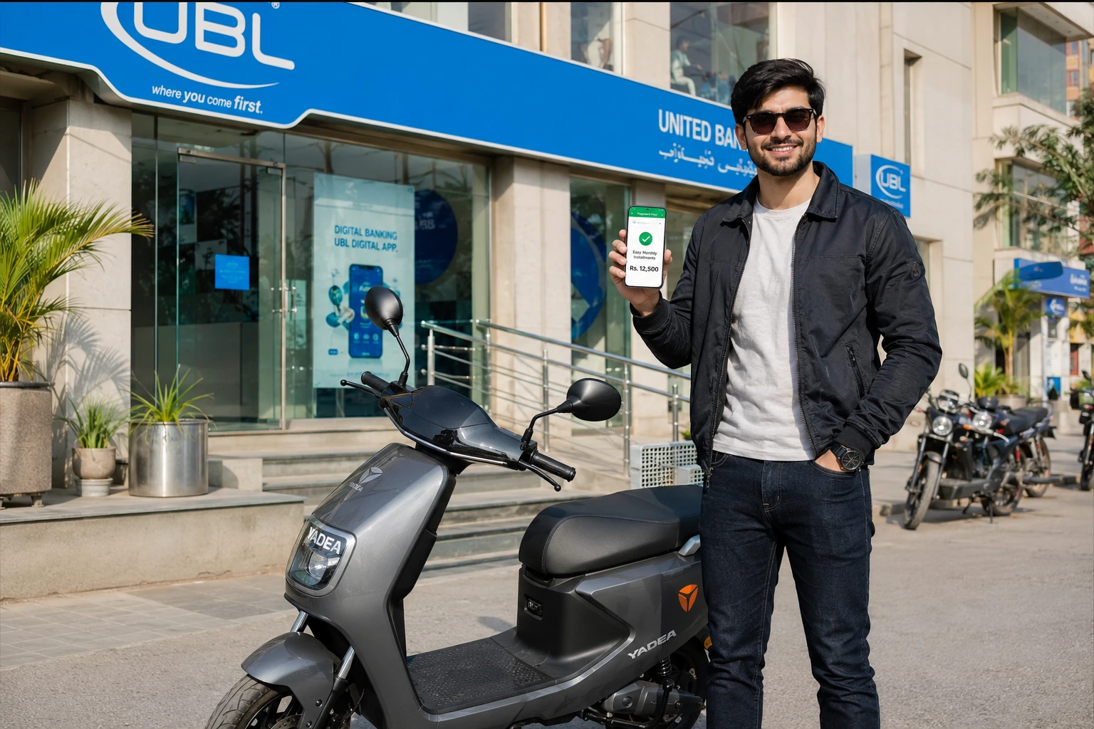 Man showing phone app beside Yadea EV: electric scooty on installments in Pakistan.
